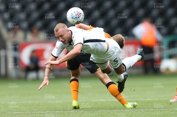 030819 - Swansea City v Hull City, Sky Bet Championship - Mike van der Hoorn of Swansea City is brought down by Daniel Batty of Hull City