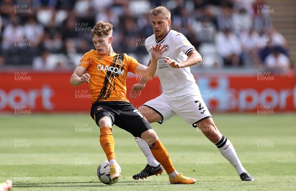 110921 - Swansea City v Hull City - SkyBet Championship - Keane Lewis-Potter of Hull City is tackled by Ryan Bennett of Swansea City