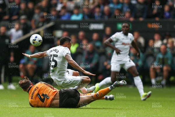 130925 - Swansea City v Hull City - Sky Bet Championship - Ronald Pereira Martin of Swansea City is tackled by Charlie Hughes of Hull City