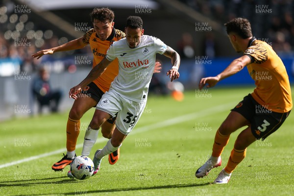 130925 - Swansea City v Hull City - Sky Bet Championship - Kyle Joseph of Hull City challenges Ronald Pereira Martin of Swansea City as Ryan Giles of Hull City looks on