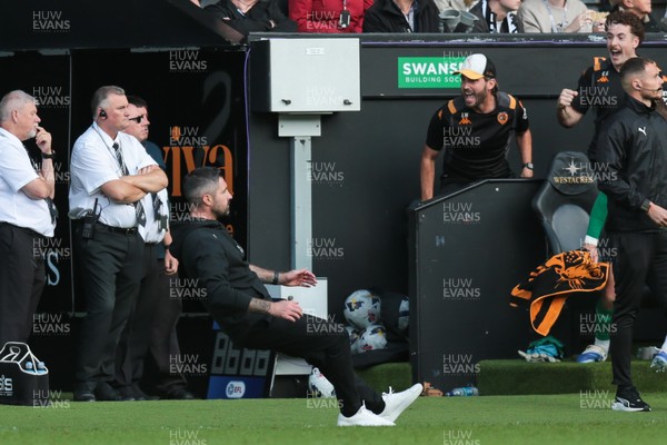 130925 - Swansea City v Hull City - Sky Bet Championship - Swansea City manager Alan Sheehan reacts by falling to the ground as Hull City score an equaliser in the 7th minute of injury time