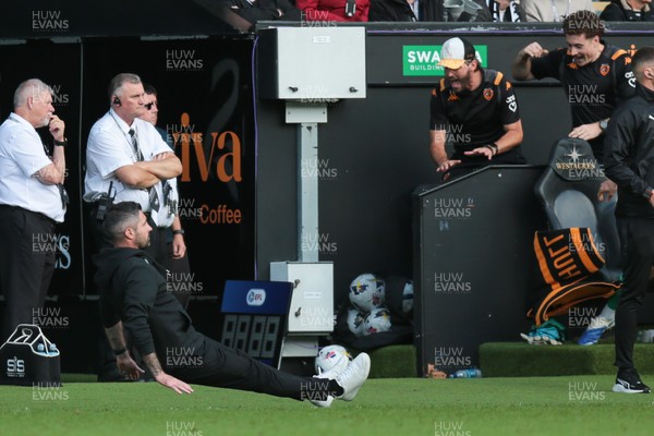 130925 - Swansea City v Hull City - Sky Bet Championship - Swansea City manager Alan Sheehan reacts by falling to the ground as Hull City score an equaliser in the 7th minute of injury time