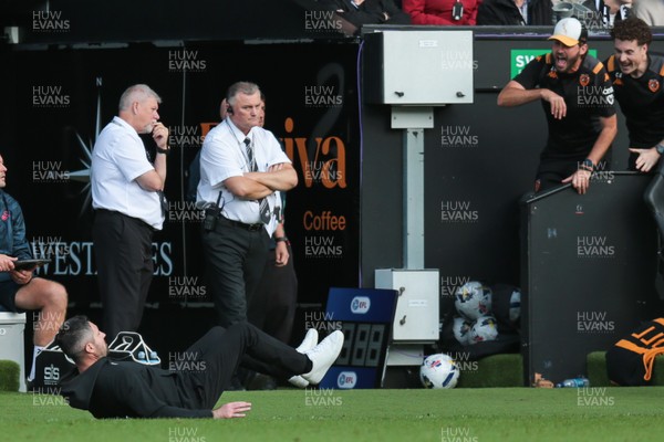130925 - Swansea City v Hull City - Sky Bet Championship - Swansea City manager Alan Sheehan reacts by falling to the ground as Hull City score an equaliser in the 7th minute of injury time