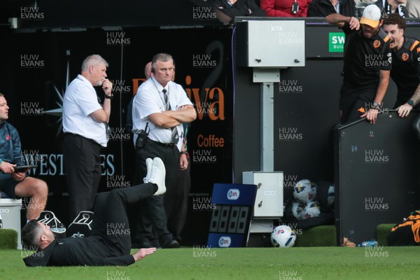 130925 - Swansea City v Hull City - Sky Bet Championship - Swansea City manager Alan Sheehan reacts by falling to the ground as Hull City score an equaliser in the 7th minute of injury time