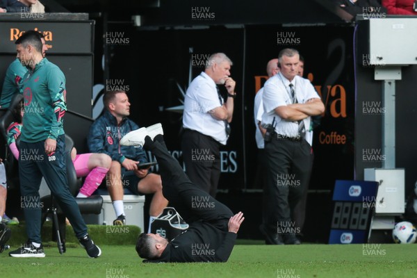 130925 - Swansea City v Hull City - Sky Bet Championship - Swansea City manager Alan Sheehan reacts by falling to the ground as Hull City score an equaliser in the 7th minute of injury time