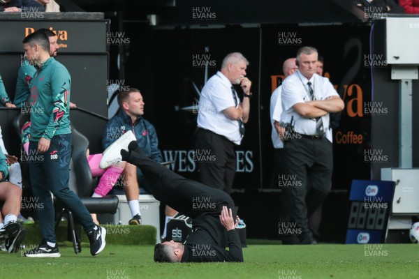 130925 - Swansea City v Hull City - Sky Bet Championship - Swansea City manager Alan Sheehan reacts by falling to the ground as Hull City score an equaliser in the 7th minute of injury time