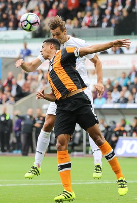 200816 - Swansea City v Hull City, Premier League - Curtis Davies of Hull City and Fernando Llorente of Swansea City compete for the ball