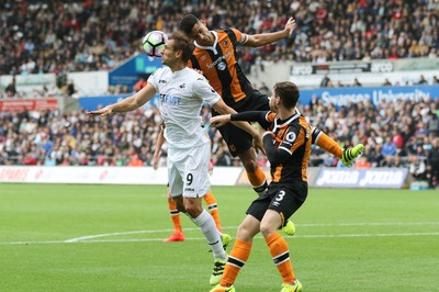 200816 - Swansea City v Hull City, Premier League - Fernando Llorente of Swansea City is challenged by Curtis Davies of Hull City and Andrew Robertson of Hull City as he goes for the ball