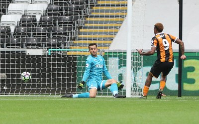 200816 - Swansea City v Hull City, Premier League - Abel Hernandez of Hull City betas Swansea City goalkeeper Lukasz Fabianski to score the second goal