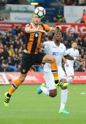 200816 - Swansea City v Hull City, Premier League -David Meyler of Hull City and Leroy Fer of Swansea City tangle as they compete for the ball