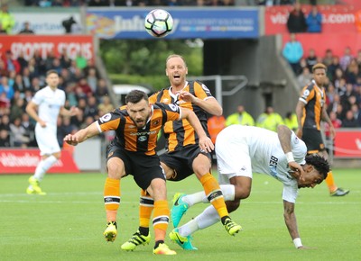 200816 - Swansea City v Hull City, Premier League -David Meyler of Hull City, Leroy Fer of Swansea City and Robert Snodgrass of Hull City tangle as they compete for the ball