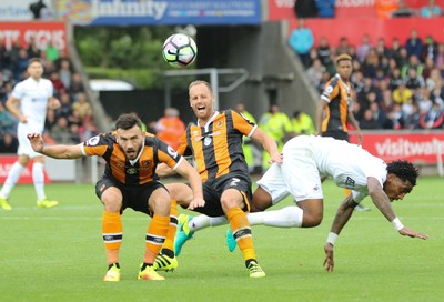 200816 - Swansea City v Hull City, Premier League -David Meyler of Hull City, Leroy Fer of Swansea City and Robert Snodgrass of Hull City tangle as they compete for the ball