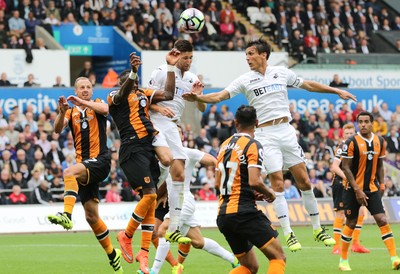 200816 - Swansea City v Hull City, Premier League - Jack Cork of Swansea City and Federico Fernandez of Swansea City try to head at goal