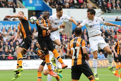 200816 - Swansea City v Hull City, Premier League -Jack Cork of Swansea City and Federico Fernandez of Swansea City try to head at goal