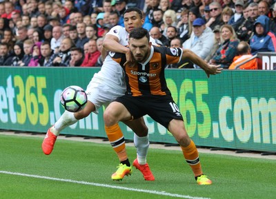 200816 - Swansea City v Hull City, Premier League - Robert Snodgrass of Hull City holds off Jefferson Montero of Swansea City as the ball goes out of play