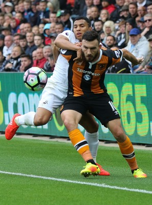 200816 - Swansea City v Hull City, Premier League - Robert Snodgrass of Hull City holds off Jefferson Montero of Swansea City as the ball goes out of play