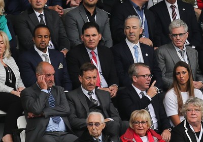 200816 - Swansea City v Hull City, Premier League - Jason Levien, centre, red tie, one of the members of the American consortium who bough the major share in Swansea City, sat behind Chairman Huw Jenkins