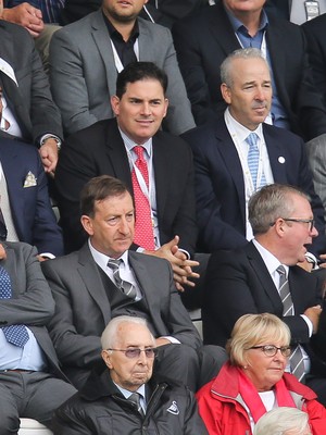 200816 - Swansea City v Hull City, Premier League - Jason Levien, centre, red tie, and Stephen Kaplan, on his left, who headed up the American consortium who bought the major share in Swansea City watch the match, sat behind Chairman Huw Jenkins