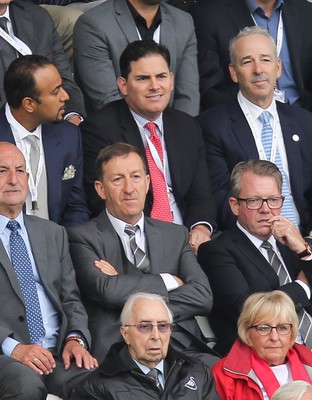 200816 - Swansea City v Hull City, Premier League - Jason Levien, centre, red tie, and Stephen Kaplan, on his left, who headed up the American consortium who bought the major share in Swansea City watch the match, sat behind Chairman Huw Jenkins