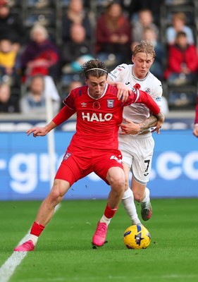 081125 - Swansea City v Ipswich Town, EFL Sky Bet Championship - Jack Clarke of Ipswich holds off Josh Key of Swansea City