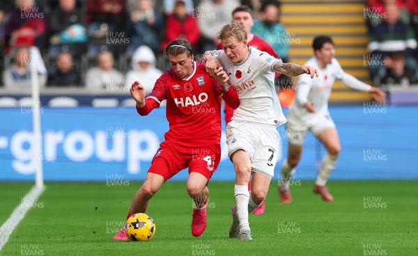 081125 - Swansea City v Ipswich Town, EFL Sky Bet Championship - Jack Clarke of Ipswich holds off Josh Key of Swansea City
