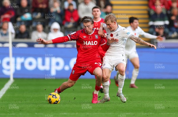 081125 - Swansea City v Ipswich Town, EFL Sky Bet Championship - Jack Clarke of Ipswich holds off Josh Key of Swansea City