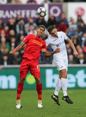 011016 - Swansea City v Liverpool, Premier League - Roberto Firmino of Liverpool and Angel Rangel of Swansea City compete for the ball