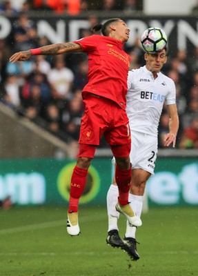 011016 - Swansea City v Liverpool, Premier League - Roberto Firmino of Liverpool and Angel Rangel of Swansea City compete for the ball