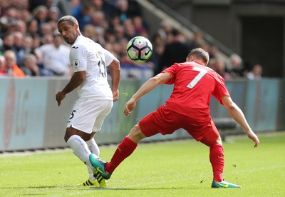 011016 - Swansea City v Liverpool, Premier League - Wayne Routledge of Swansea City flicks the ball past James Milner of Liverpool