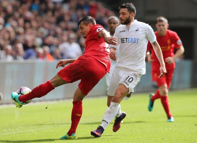 011016 - Swansea City v Liverpool, Premier League - Dejan Lovren of Liverpool clears the ball as Borja Gonzalez of Swansea City closes in