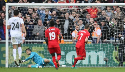 011016 - Swansea City v Liverpool, Premier League - James Milner of Liverpool beats Swansea City goalkeeper Lukasz Fabianski from the penalty spot to score the second goal