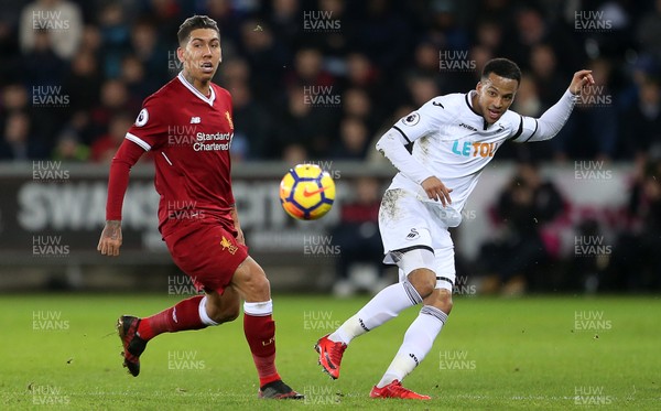 220118 - Swansea City v Liverpool - Premier League - Martin Olsson of Swansea City is challenged by Roberto Firmino of Liverpool