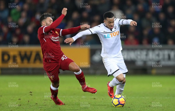 220118 - Swansea City v Liverpool - Premier League - Martin Olsson of Swansea City is tackled by Alex Oxlade-Chamberlain of Liverpool