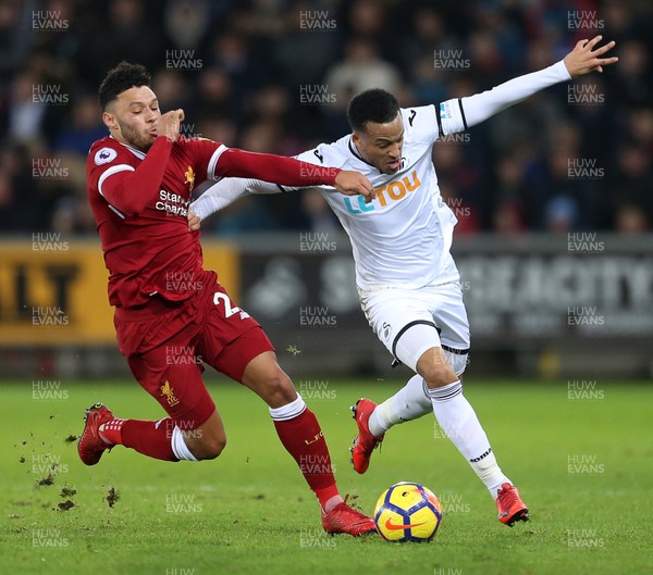 220118 - Swansea City v Liverpool - Premier League - Martin Olsson of Swansea City is tackled by Alex Oxlade-Chamberlain of Liverpool