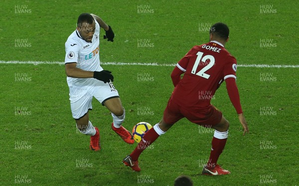220118 - Swansea City v Liverpool - Premier League - Jordan Ayew of Swansea City is tackled by Joe Gomez of Liverpool