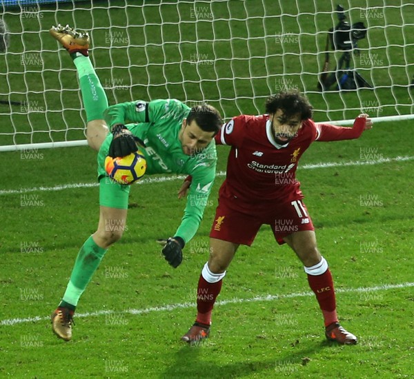 220118 - Swansea City v Liverpool - Premier League - lukasz Fabianski of Swansea City collides with Mohamed Salah of Liverpool