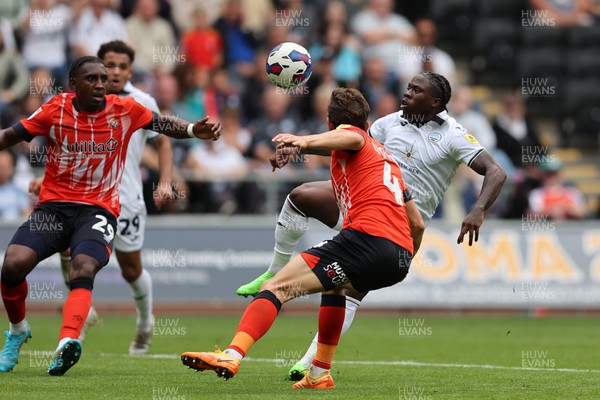 200822 - Swansea City v Luton Town - Sky Bet Championship - Michael Obafemi of Swansea City (r) & Tom Lockyer of Luton Town (4) in action 