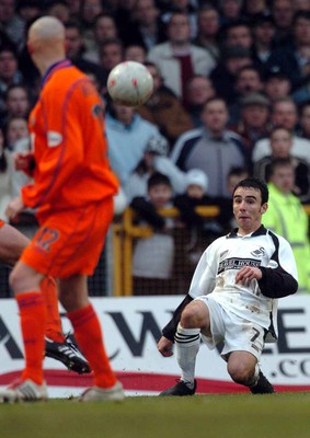 3-02-04 Swansea City v Macclesfield Town Swansea's Leon Britton lofts cross over Danny Whitaker  