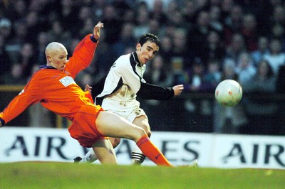 3-02-04 Swansea City v Macclesfield Town Swansea's Leon Britton gets shot past Danny Whittaker  