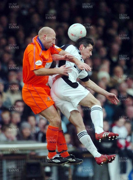 3-02-04 Swansea City v Macclesfield Town Swansea's Leon Britton wins ball against Danny Adams  