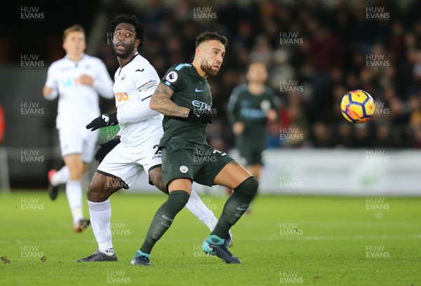 131217 - Swansea City v Manchester City, Premier League - Wilfried Bony of Swansea City and Nicolas Otamendi of Manchester City compete for the ball