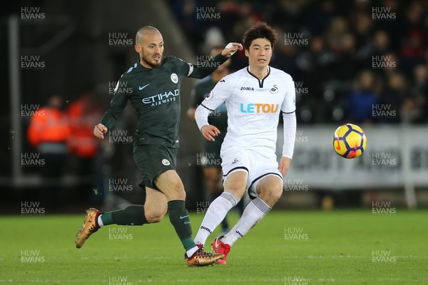 131217 - Swansea City v Manchester City, Premier League - David Silva of Manchester City wins the ball from Ki Sung-Yueng of Swansea City
