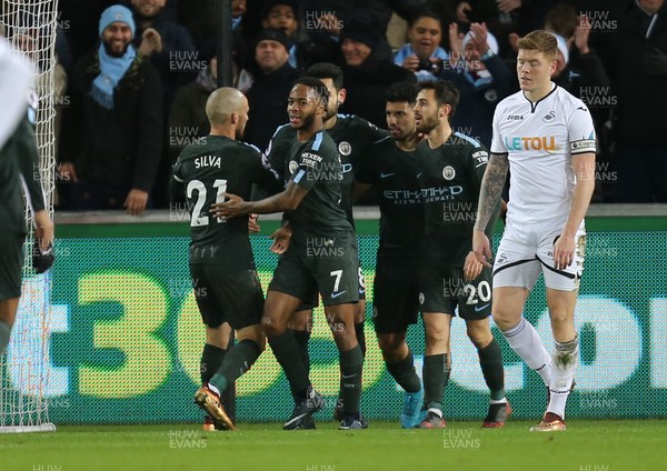 131217 - Swansea City v Manchester City, Premier League - Manchester City players celebrate with Sergio Aguero after he scores the fourth goal