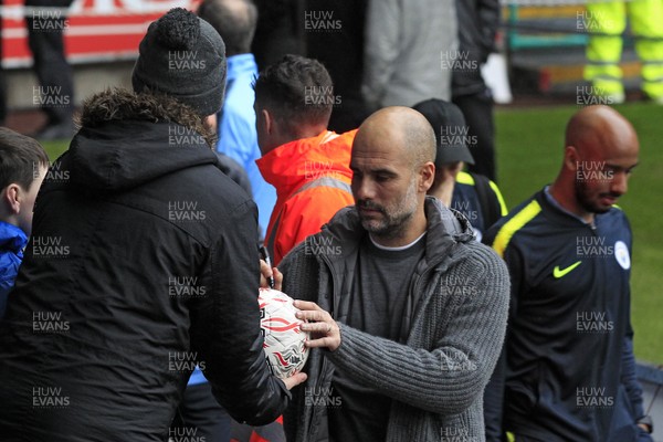 160319 - Swansea City v Manchester City, FA Cup Sixth Round - Manchester City Manager Pep Guardiola signs autographs for fans as he arrives at Liberty Stadium