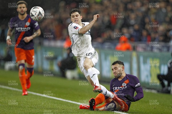 160319 - Swansea City v Manchester City, FA Cup Sixth Round - Daniel James of Swansea City (left) and Nicolas Otamendi of Manchester City battle for the ball