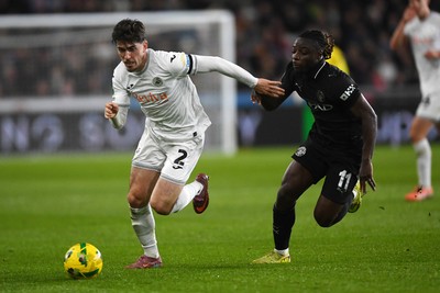 291025 - Swansea City v Manchester City - Carabao Cup Round 4 - Josh Key of Swansea City is challenged by Jeremy Doku of Manchester City