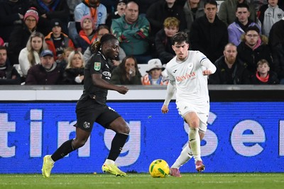 291025 - Swansea City v Manchester City - Carabao Cup Round 4 - Josh Key of Swansea City is challenged by Jeremy Doku of Manchester City