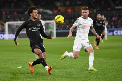 291025 - Swansea City v Manchester City - Carabao Cup Round 4 - Oscar Bobb of Manchester City is challenged by Josh Tymon of Swansea City