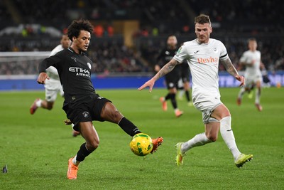 291025 - Swansea City v Manchester City - Carabao Cup Round 4 - Oscar Bobb of Manchester City is challenged by Josh Tymon of Swansea City