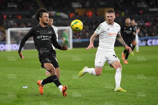 291025 - Swansea City v Manchester City - Carabao Cup Round 4 - Oscar Bobb of Manchester City is challenged by Josh Tymon of Swansea City